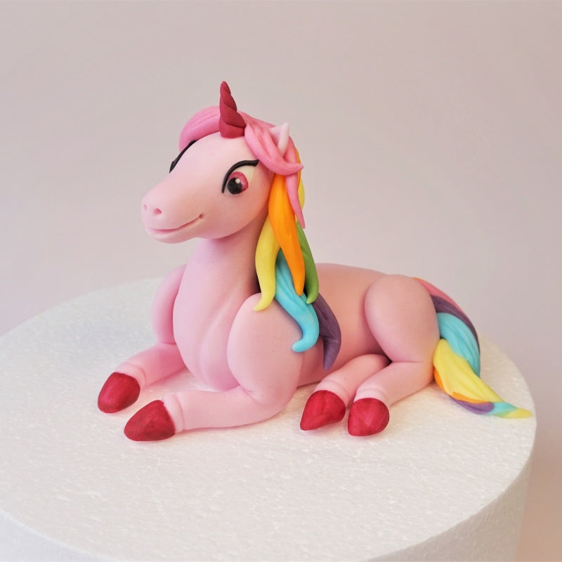 Fondant pink unicorn cake topper